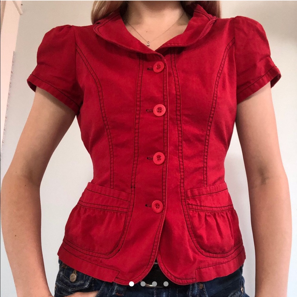 Adorable bright red button up top.